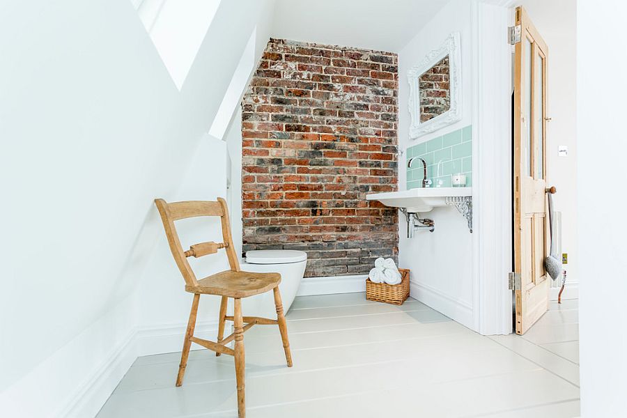 Front of an old chimney breast turned into a feature brick wall in the beach style bathroom