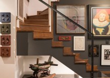 Gallery-wall-next-to-the-staircase-and-a-unique-decorative-piece-under-it-217x155