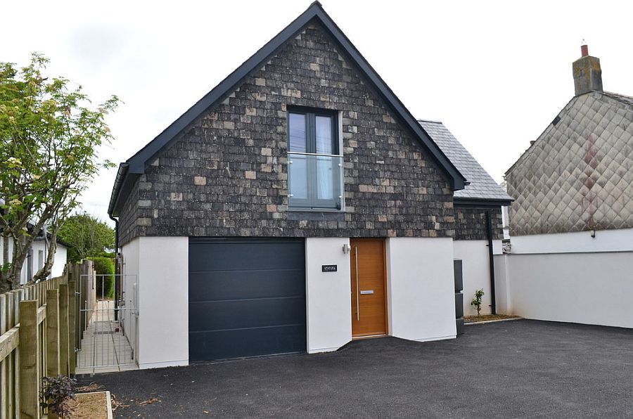 Glass Juliet balcony above the garage blends into the contemporary backdrop [Design: Joan Kinnane Architect]