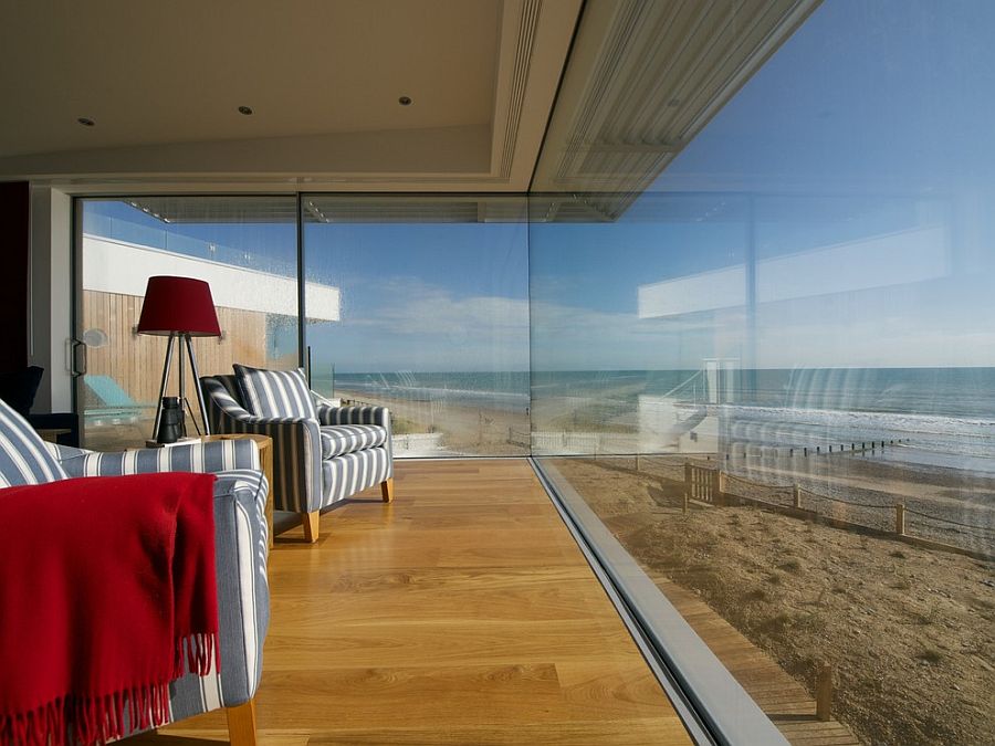 Glass walls completely open up the living room to the ocean view on offer