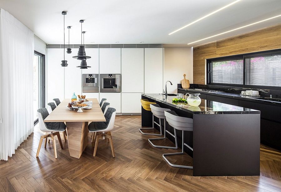 Herringbone flooring adds pattern to the neutral kitchen and dining