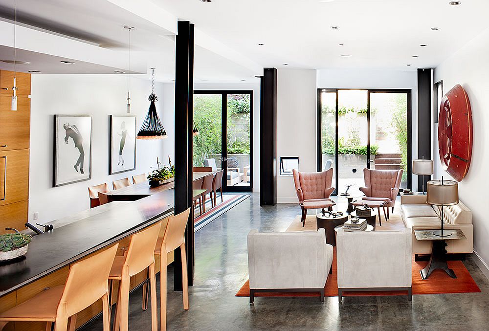 Iconic midcentury decor, creative artwork and industrial lighting shape the open plan living area