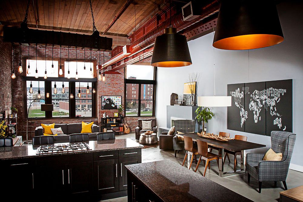 Industrial kitchen and living area of loft with exposed brick walls