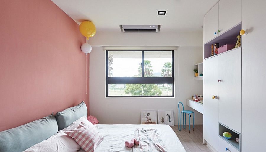 Kids' bedroom with a pink accent wall