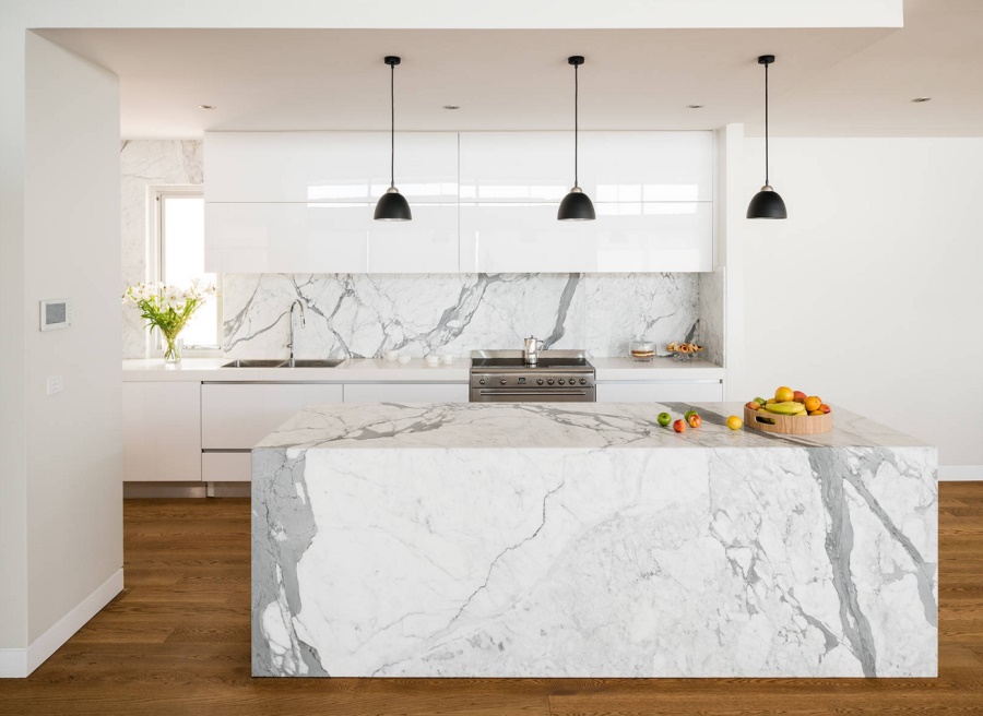 Kitchen with marble and hanging pendant lights