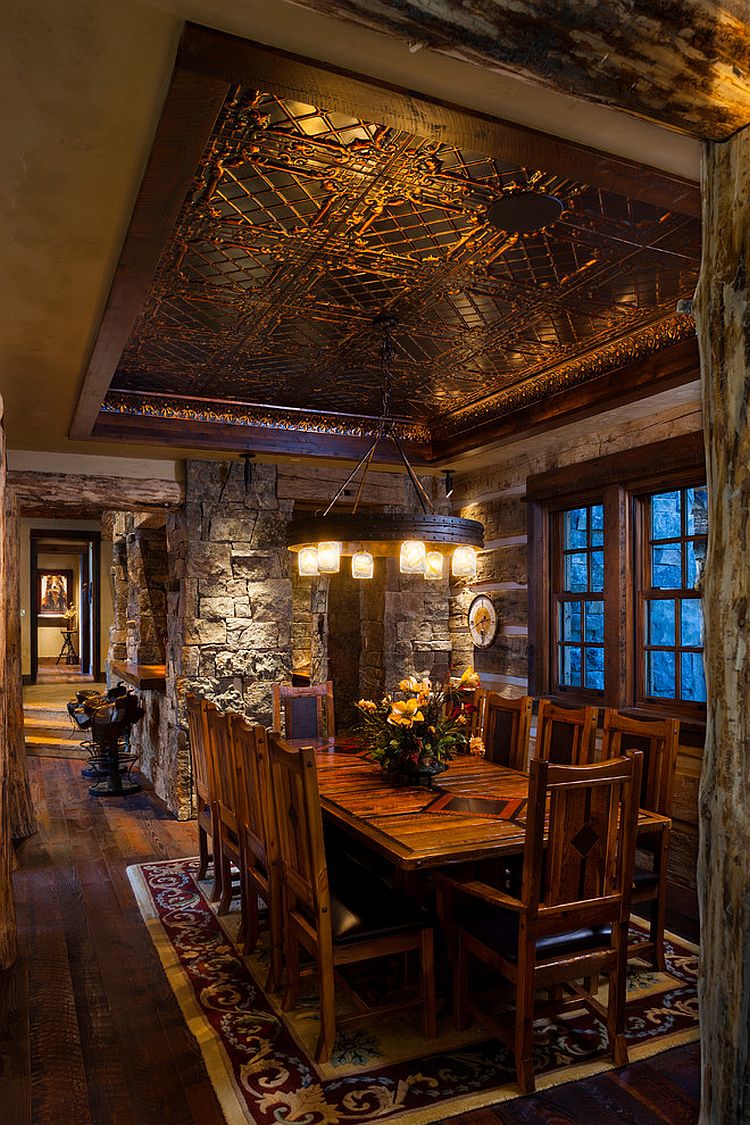 Log cabin dining room crafted from stone and reused materials [Design: Teton Heritage Builders]