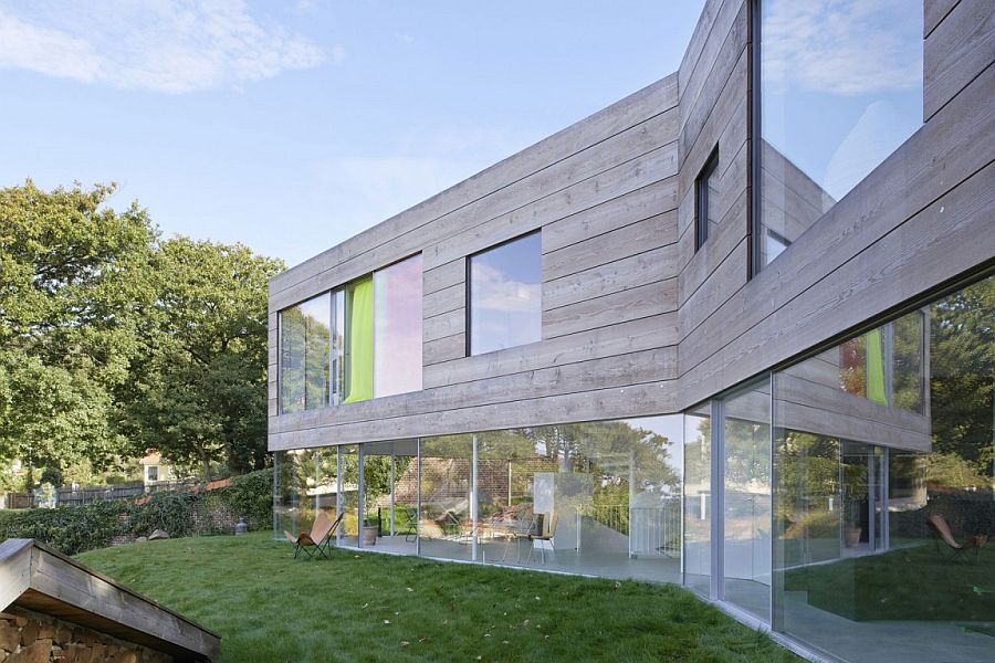Lower level of the family home is completely clad in glass walls and floor-to-ceiling doors