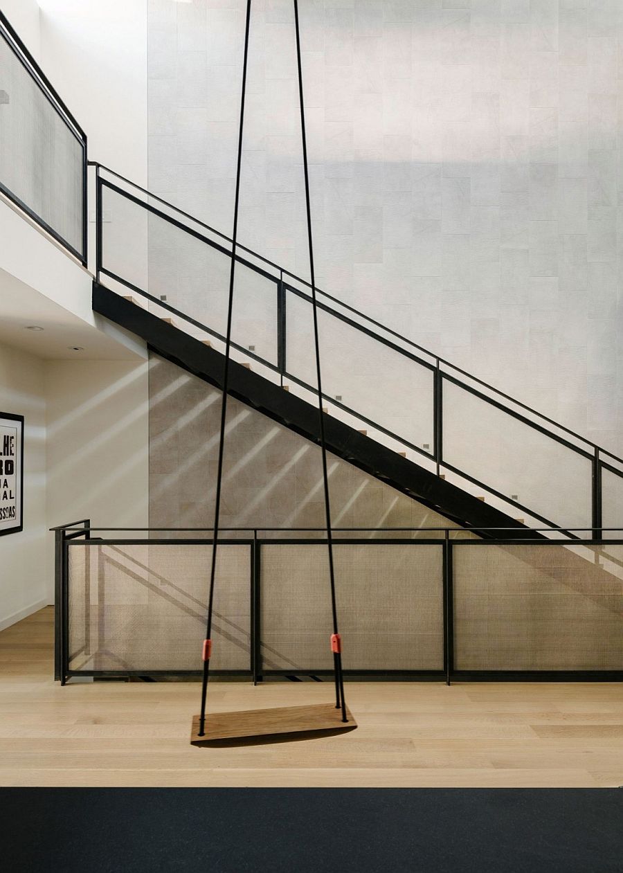 Metal-screened stair, backed by a tiled feature wall