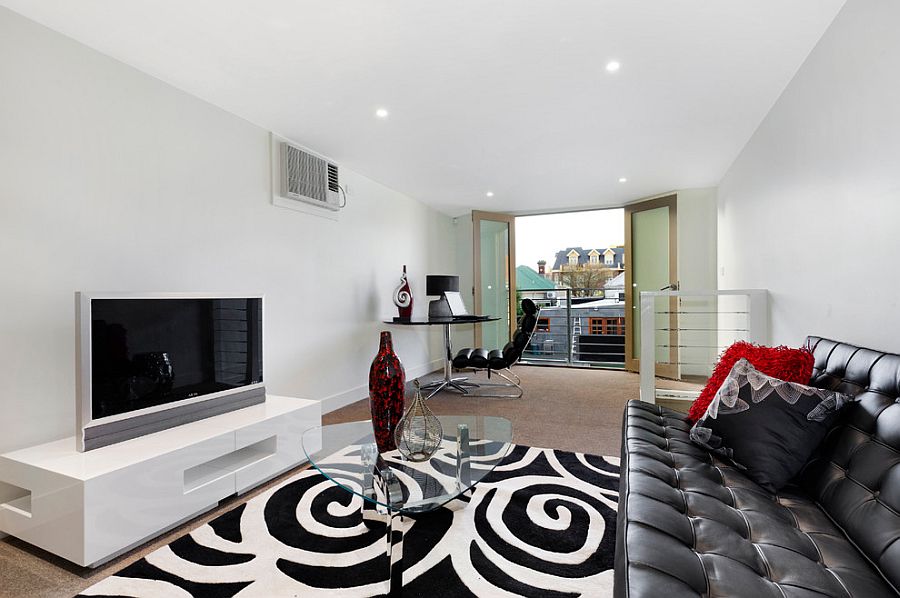 Modern family room with double doors that open onto Juliet balcony [Design: Bagnato Architects]