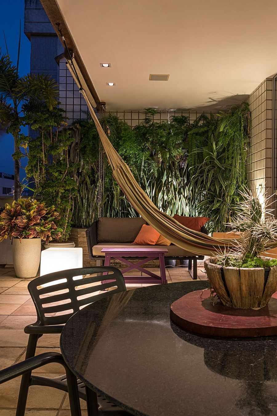 Natural greenery and hammock create an urban retreat on the top level of the penthouse