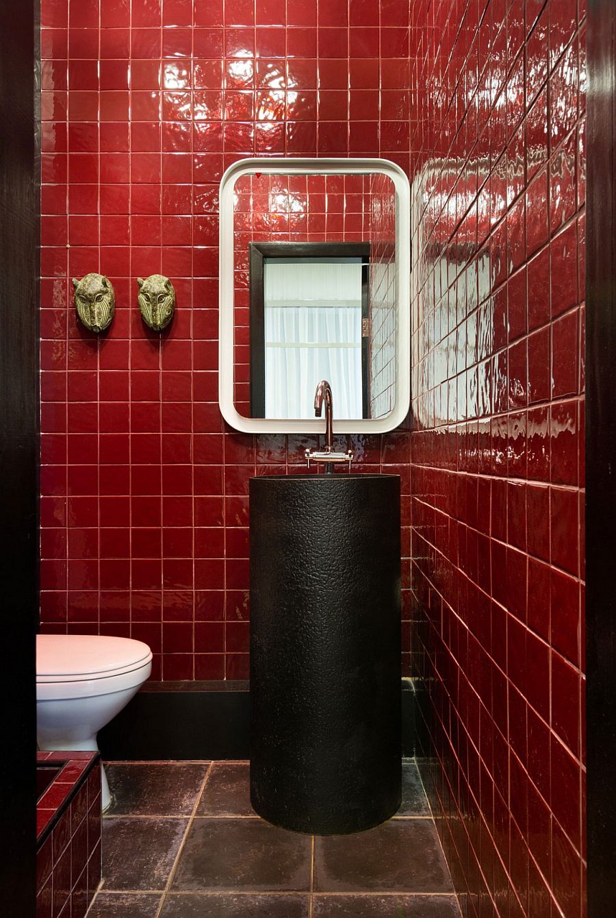 Red tile create a unique and stylish bathroom with touches of black