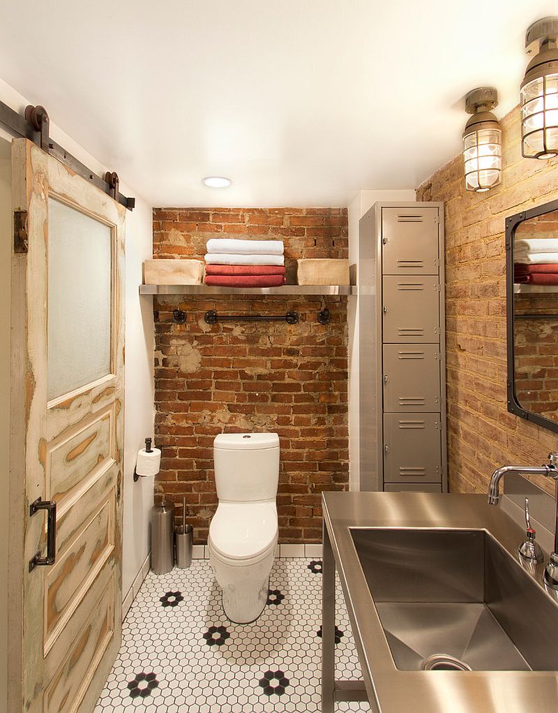 Salvaged decor shapes small industrial bathroom with exposed brick walls