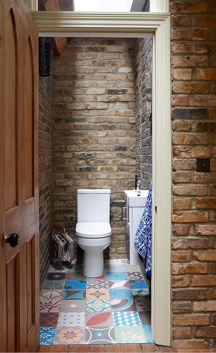 Small rustic bathroom with brick walls and skylight