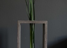 Transparent-glass-tube-vase-in-grey-concrete-stand-217x155