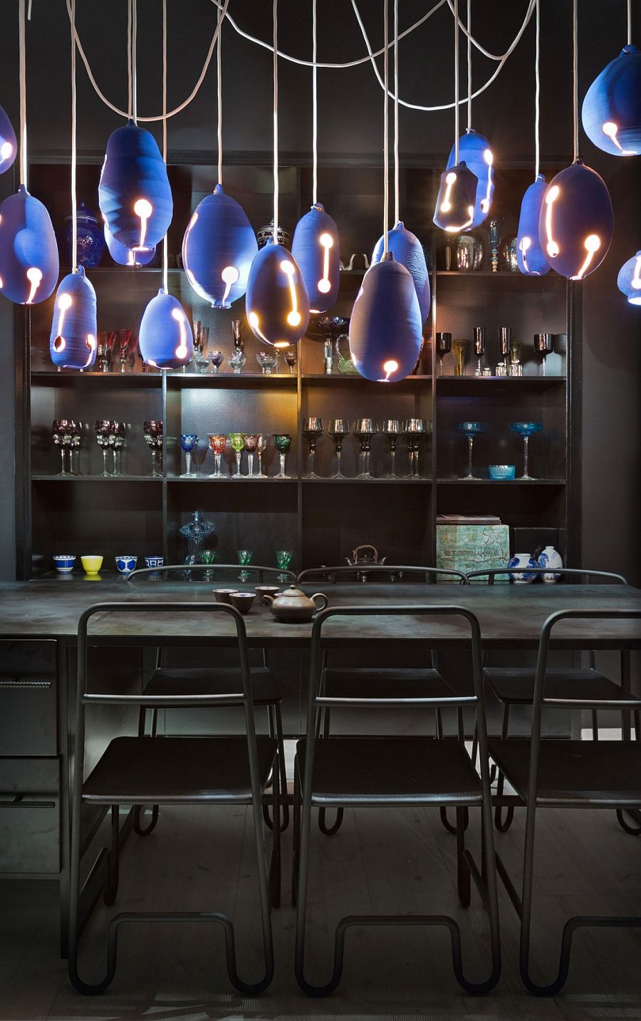 Vintage colored glasses and bold lighting for the dark dining area