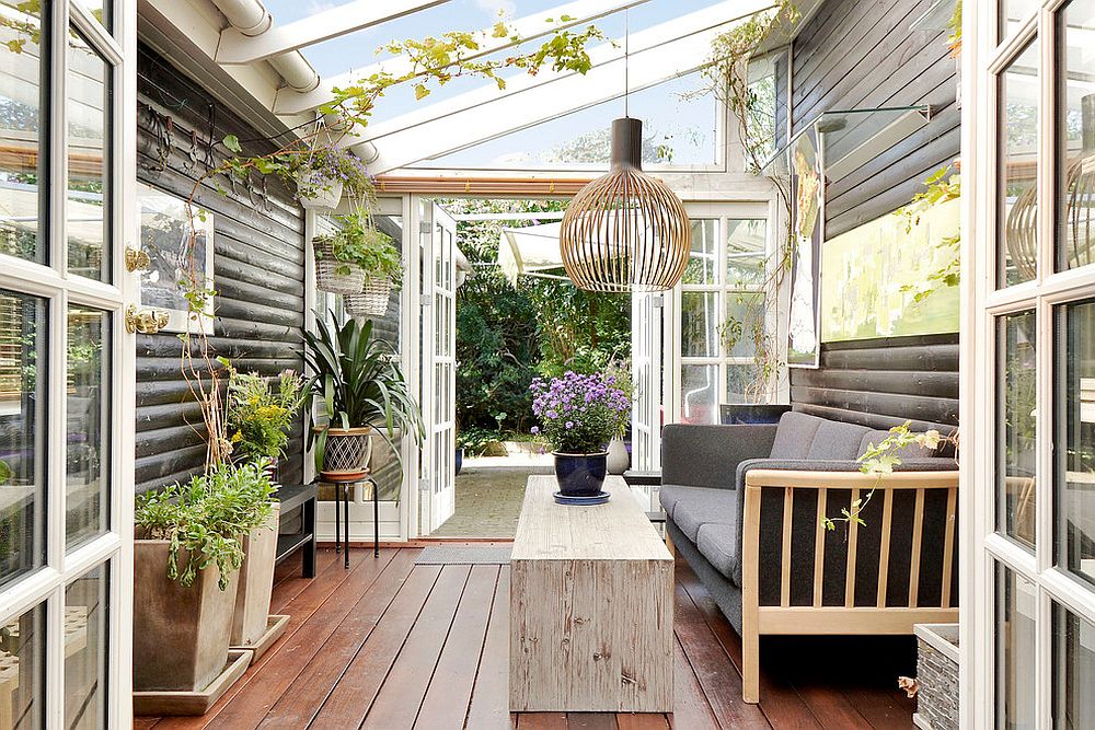 Beautiful Scandinavian sunroom with glass roof and Seppo Koho pendant lighting