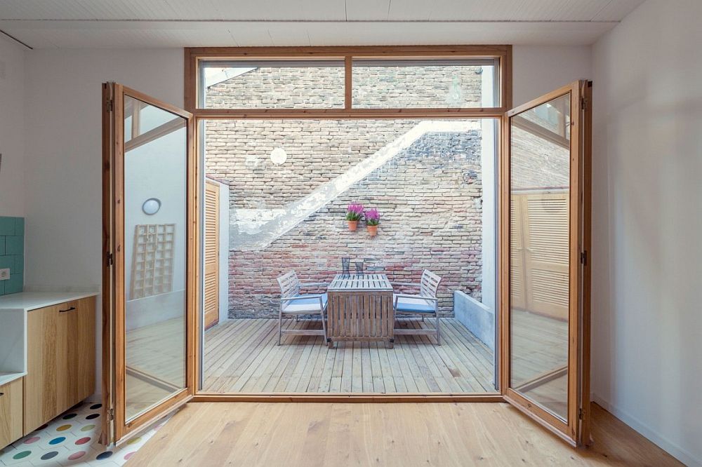 Brick wall and outddor deck of the renoavted row house in Barcelona