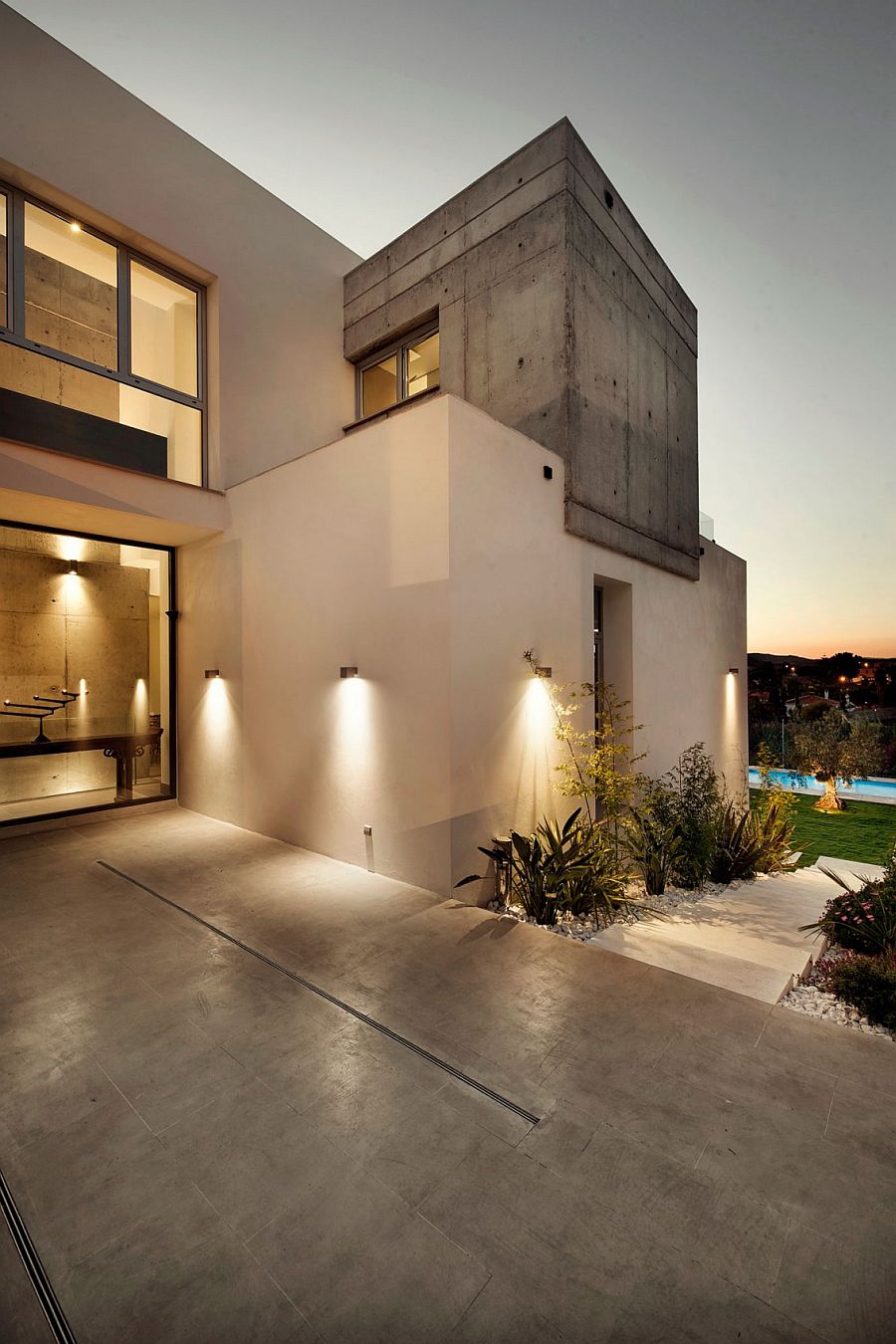 Clever lighting accentuates the garden features and illuminates the walkway