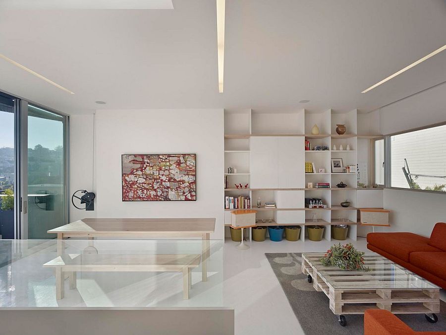 Coffee table on wheel and couch in bright orange for the contemporary living space