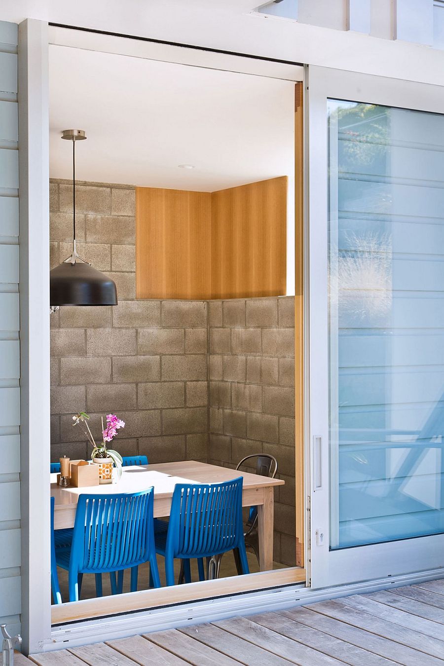 Colorful chairs create a vivacious dining room