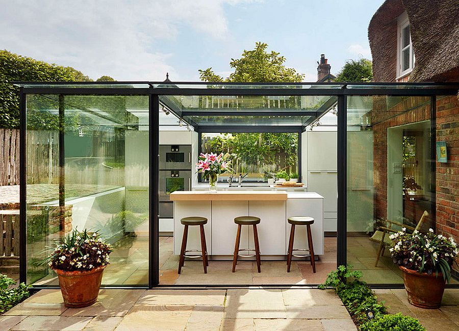 Contemporary glass kitchen extension for classic 18th century cottage in England