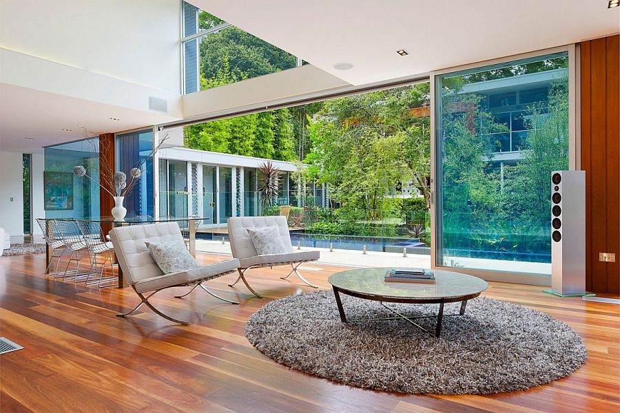 Contemporary interior with large glass wall and wooden flooring