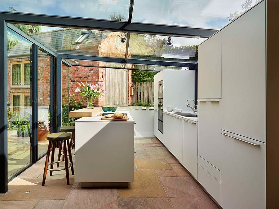 Cool Bulthaup kitchen encased in a glass box with steel frame and a stylish island