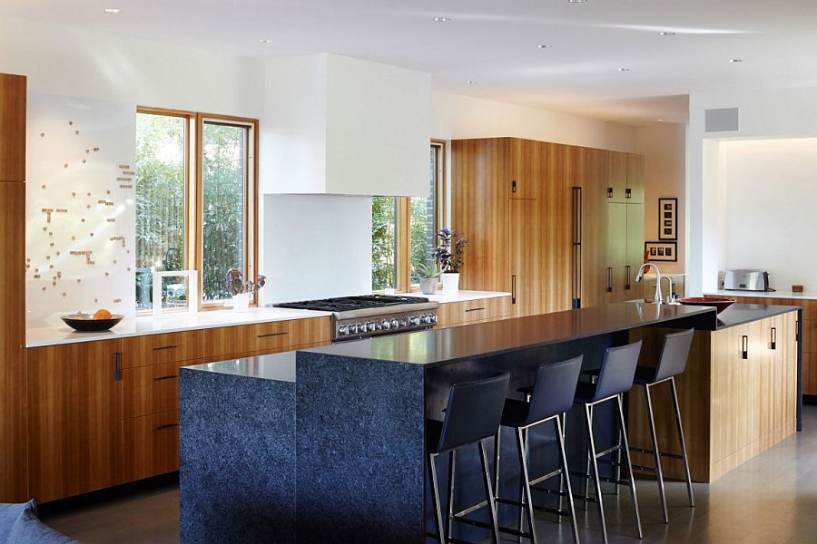 Custom stone kitchen island that extends into a breakfast zone