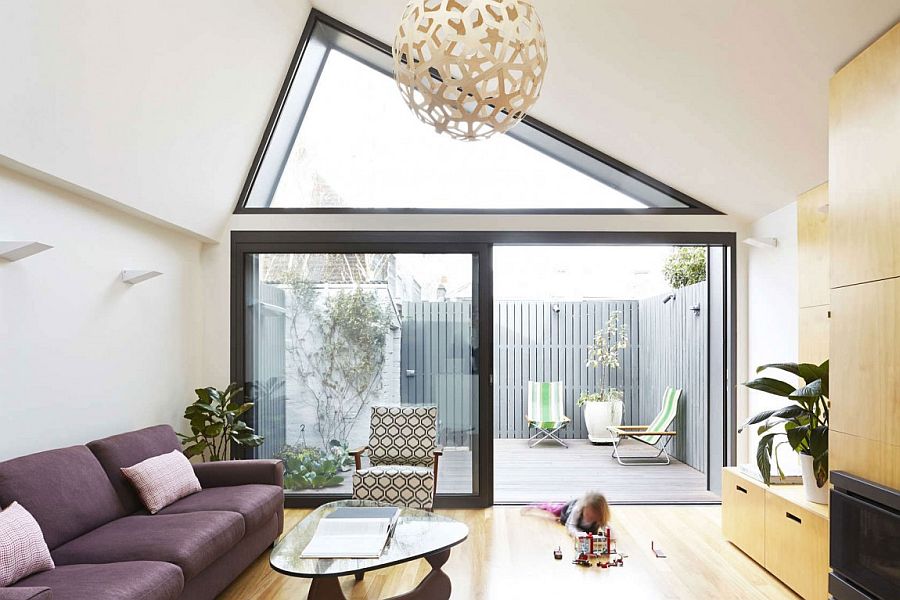 Elegant living area with a bright purple couch connected with the rear patio