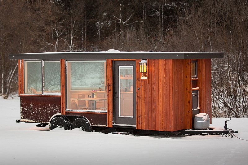 Exterior of gorgeous tiny home with cedar vertical siding and Cor-ten Steel panels