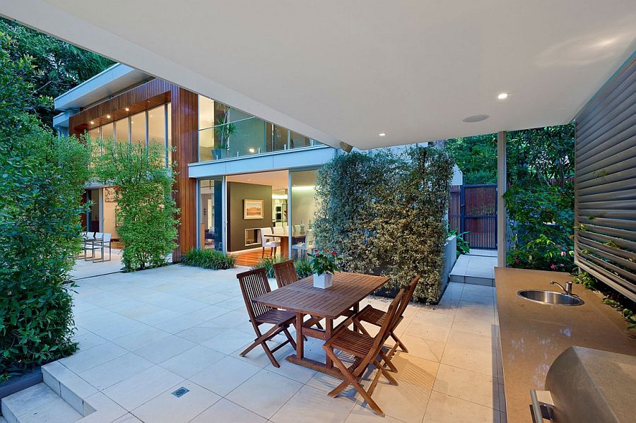 Gorgeous barbeque and sitting zone draped in greenery