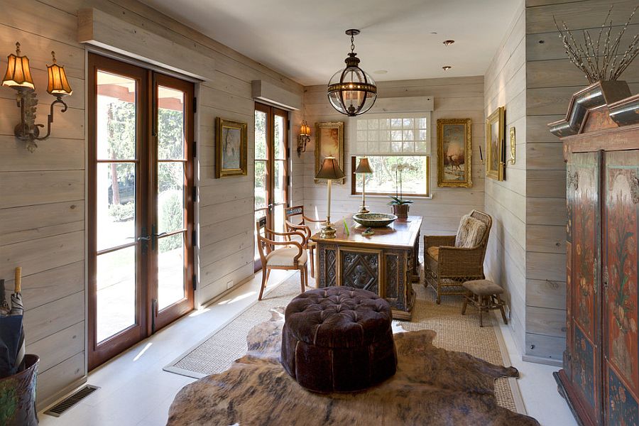 Gorgeous sconce lighting and chandelier adds to the shabby chic aura of this spacious home office