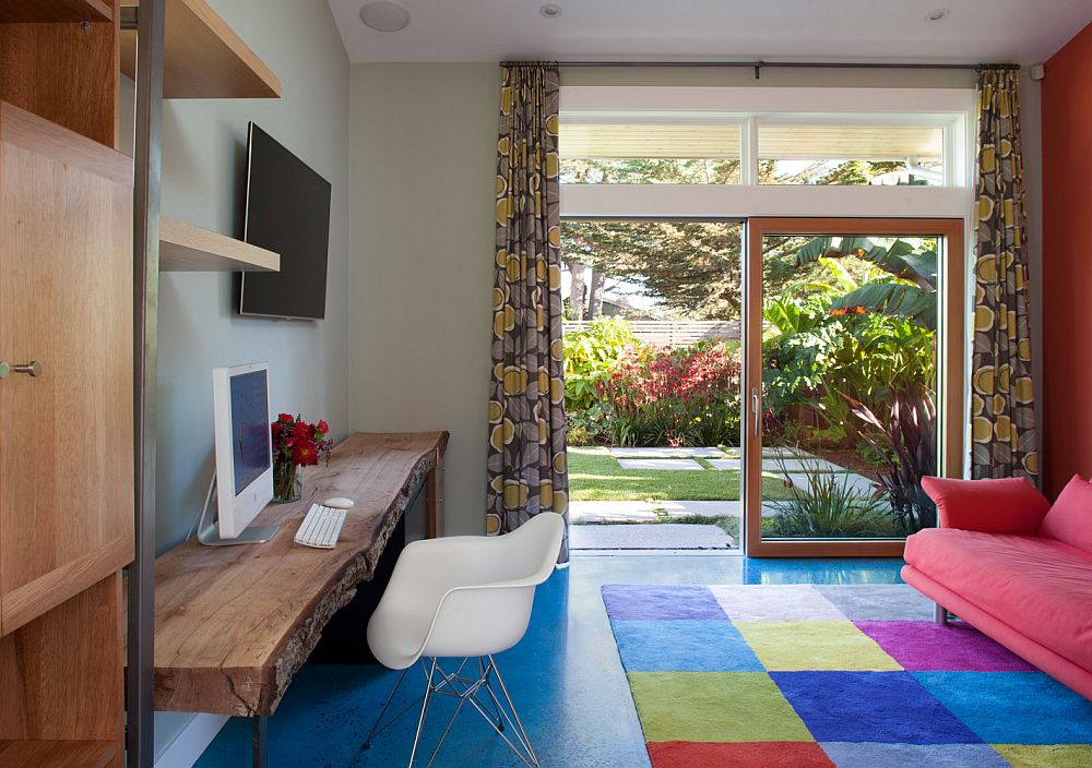 Home office with colorful rug and a live-edge table