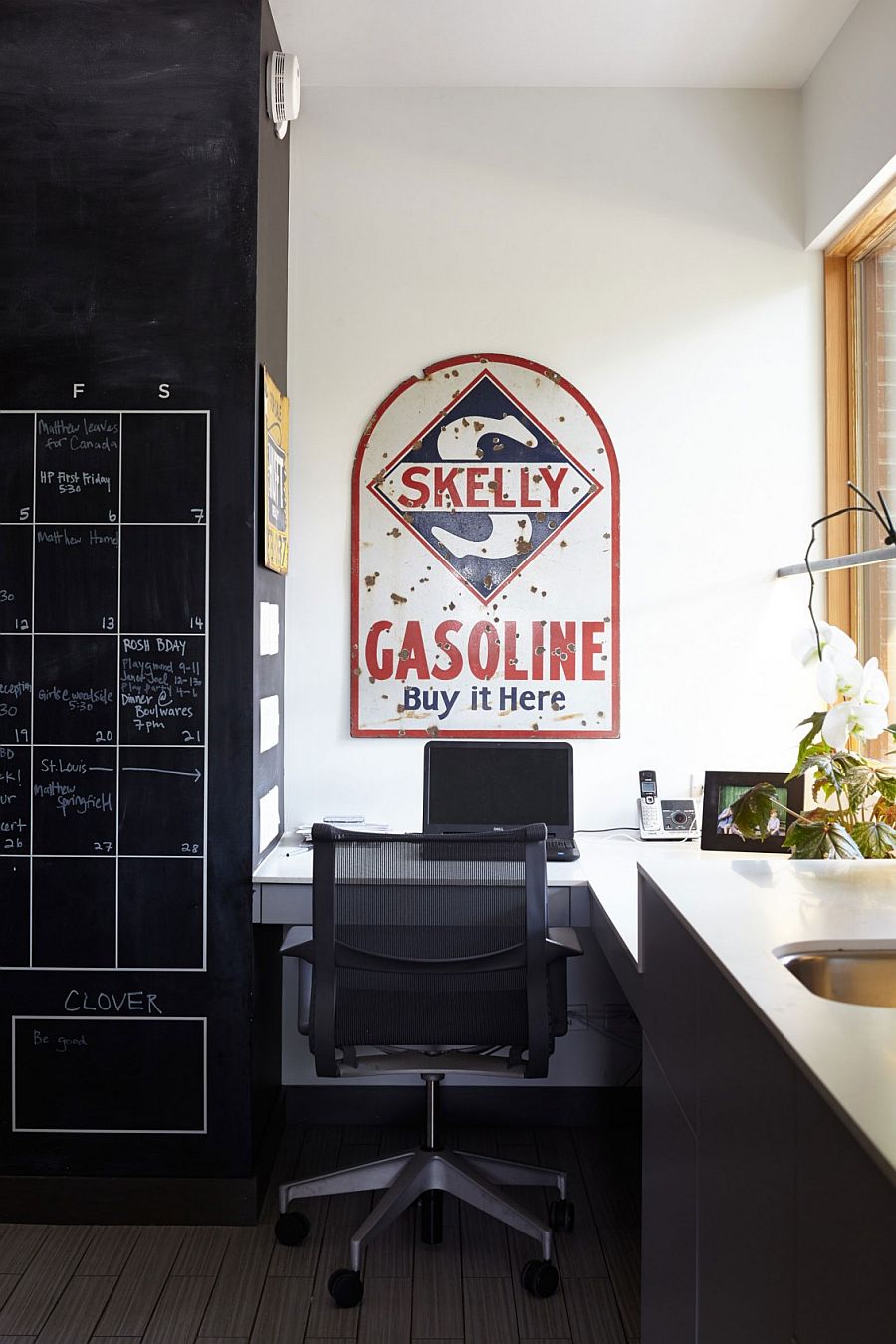 Home office with corner workspace and chalkboard wall