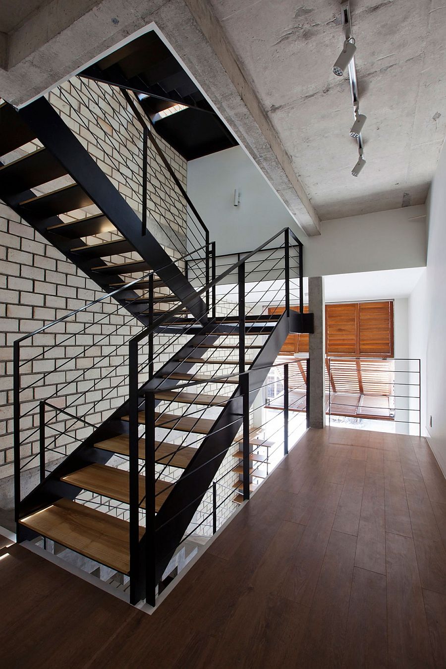 Industrial staircase connects the various levels of the home