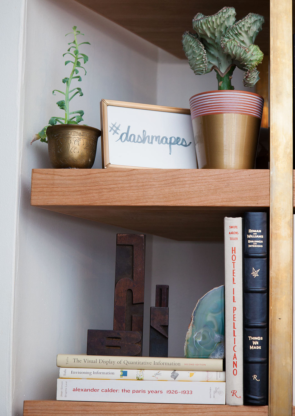 Interesting objects on a styled bookshelf