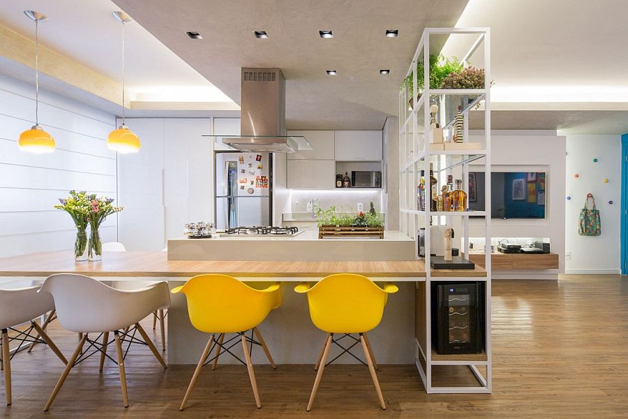 Kitchen and dining space rolled into one inside the clever apartment in Brasilla