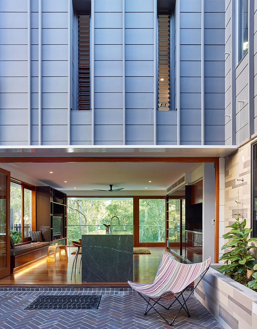 Kitchen and living spaces in the rear building open up towards the pool outside