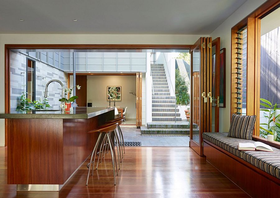 Kitchen counter and bar stoools along with tehe window seat create a cool family zone