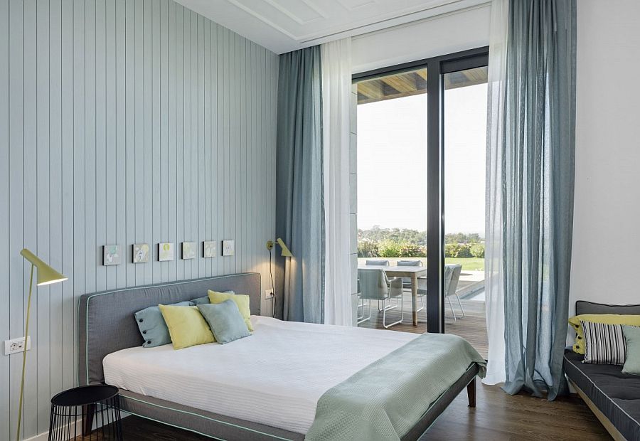 Large glass doors connect the bedroom with the deck space outside