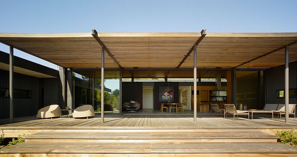 Large, shaded wooden deck extends the living area outdoors