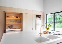 Large-window-with-dark-frame-brings-natural-ventilation-into-the-kitchen-217x155