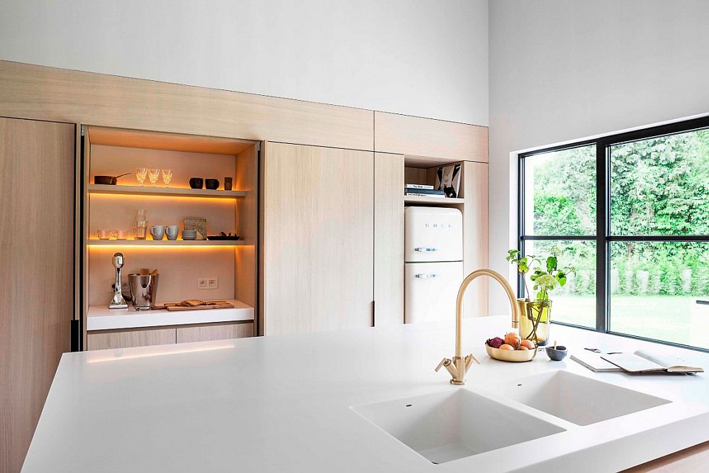 Large window with dark frame brings natural ventilation into the kitchen