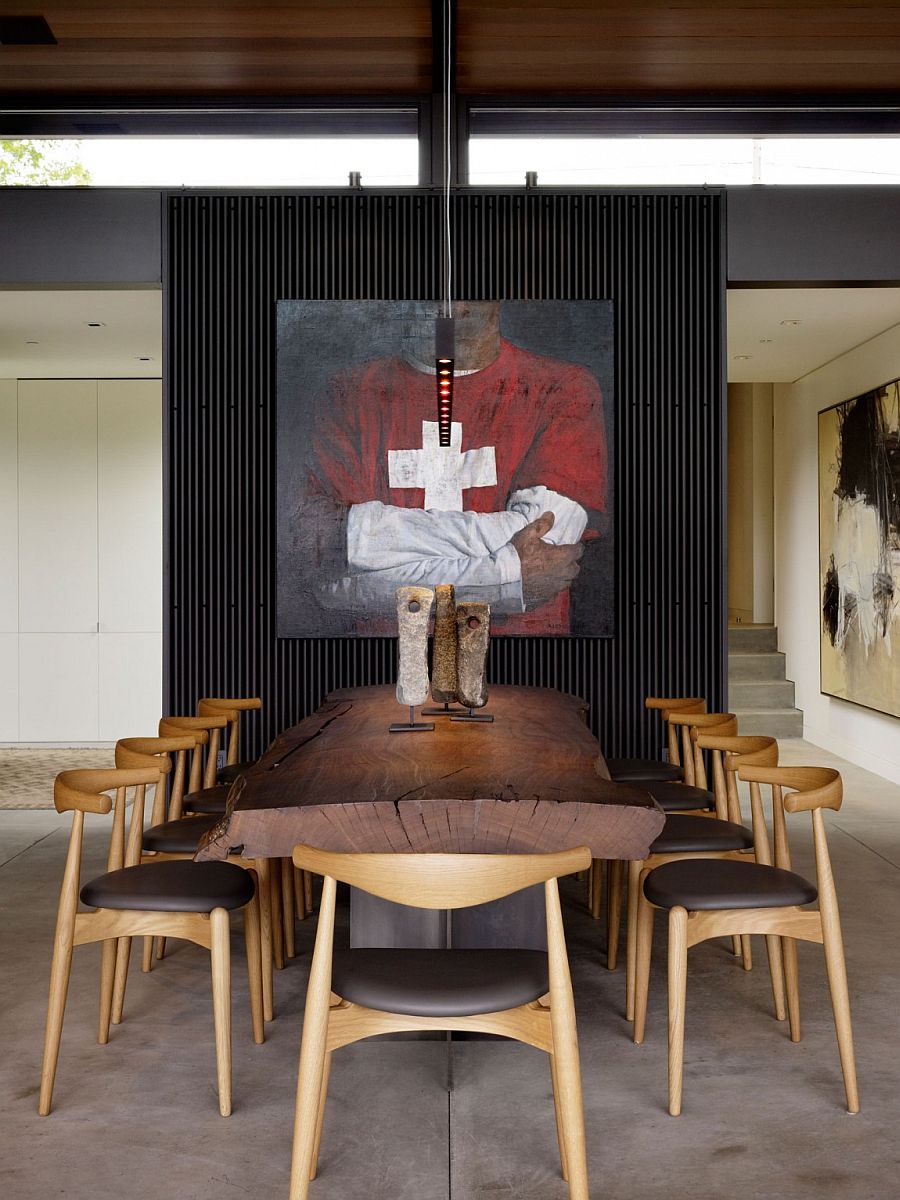 Live-edge dining table plays into the raw, industrial theme of the living room