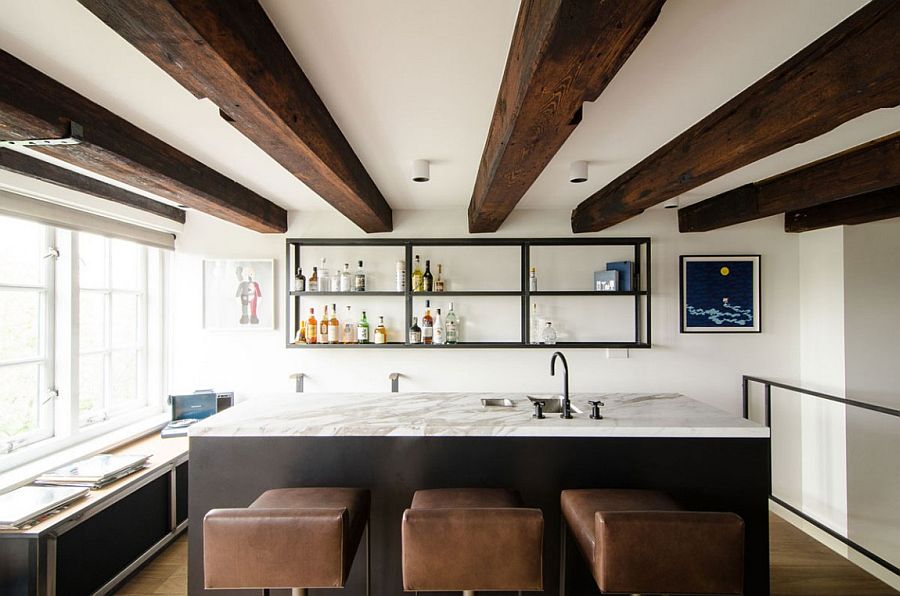 Marble kitchen island and leather bar stools add a hint of luxury to the setting