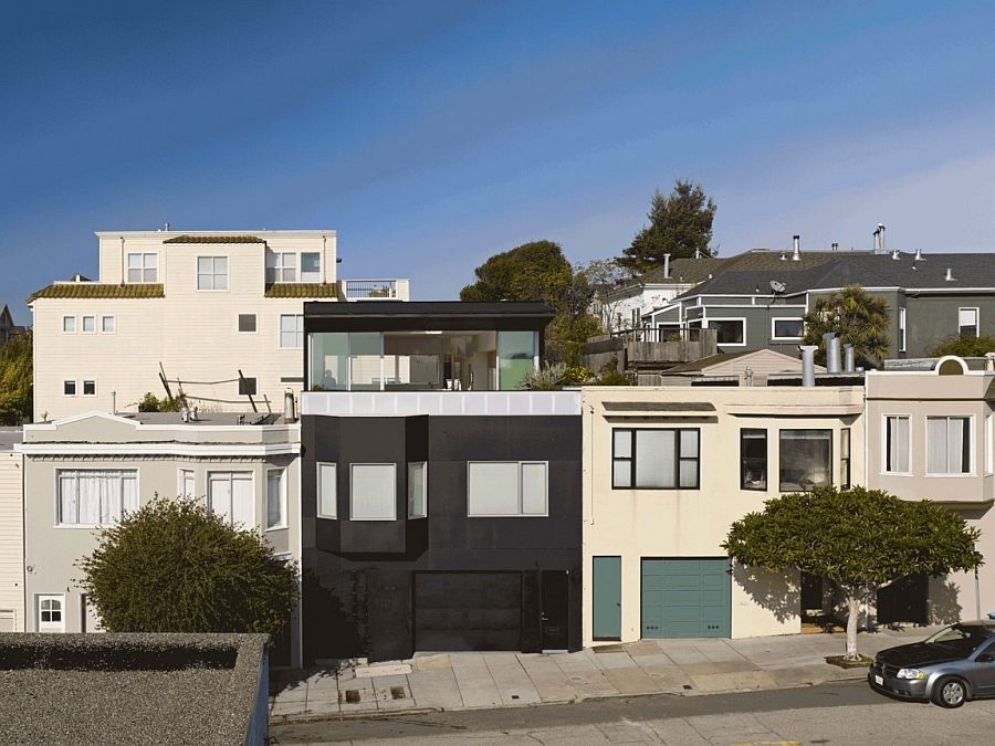 Matte black cladding used in skateboard ramps shapes the home's exterior