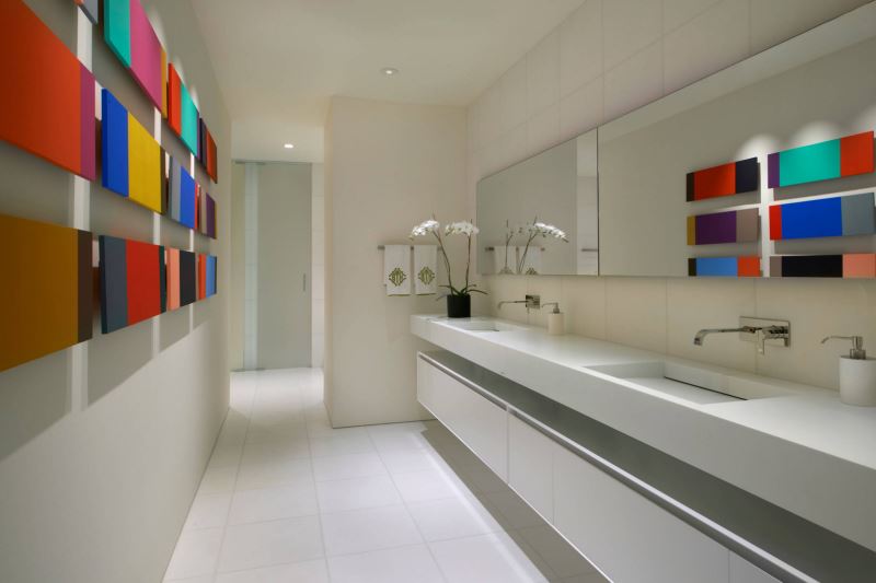 Modern artwork decorates a bathroom wall