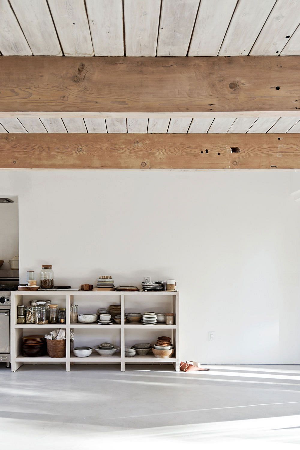 Open kitchen cabinetry with collection of studio pottery