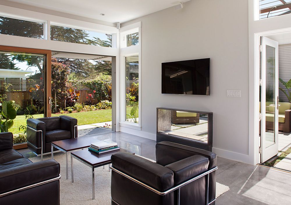 Open living room with sliding glass doors surrounded by the backyard