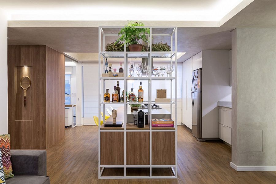 Open metallic shelf serves both the kitchen and living area
